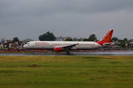 Air India aircraft on runway with investigation team in background
